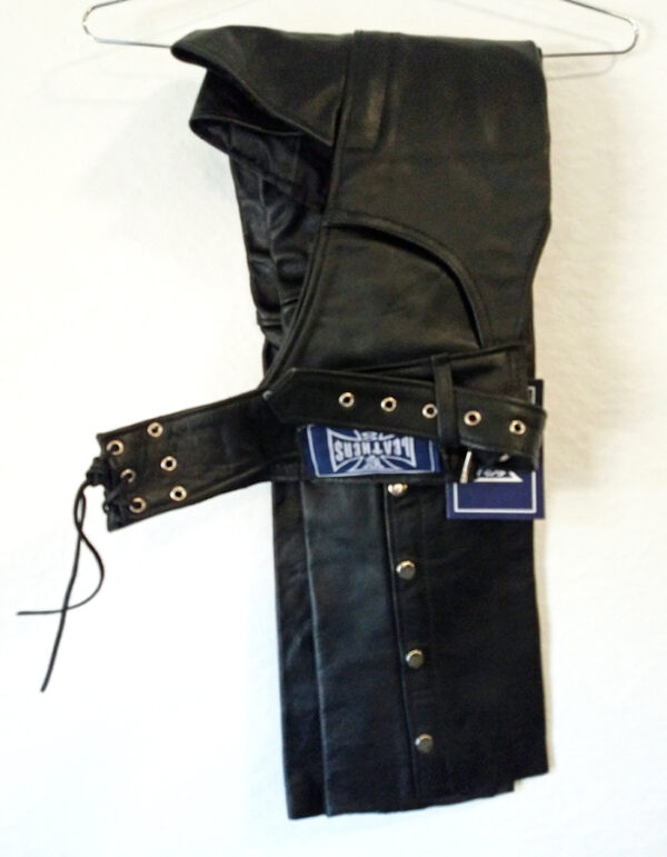 Black leather chaps hanging on wall