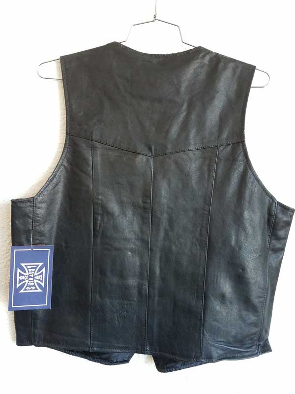 Rear plain black vest hanging on wall